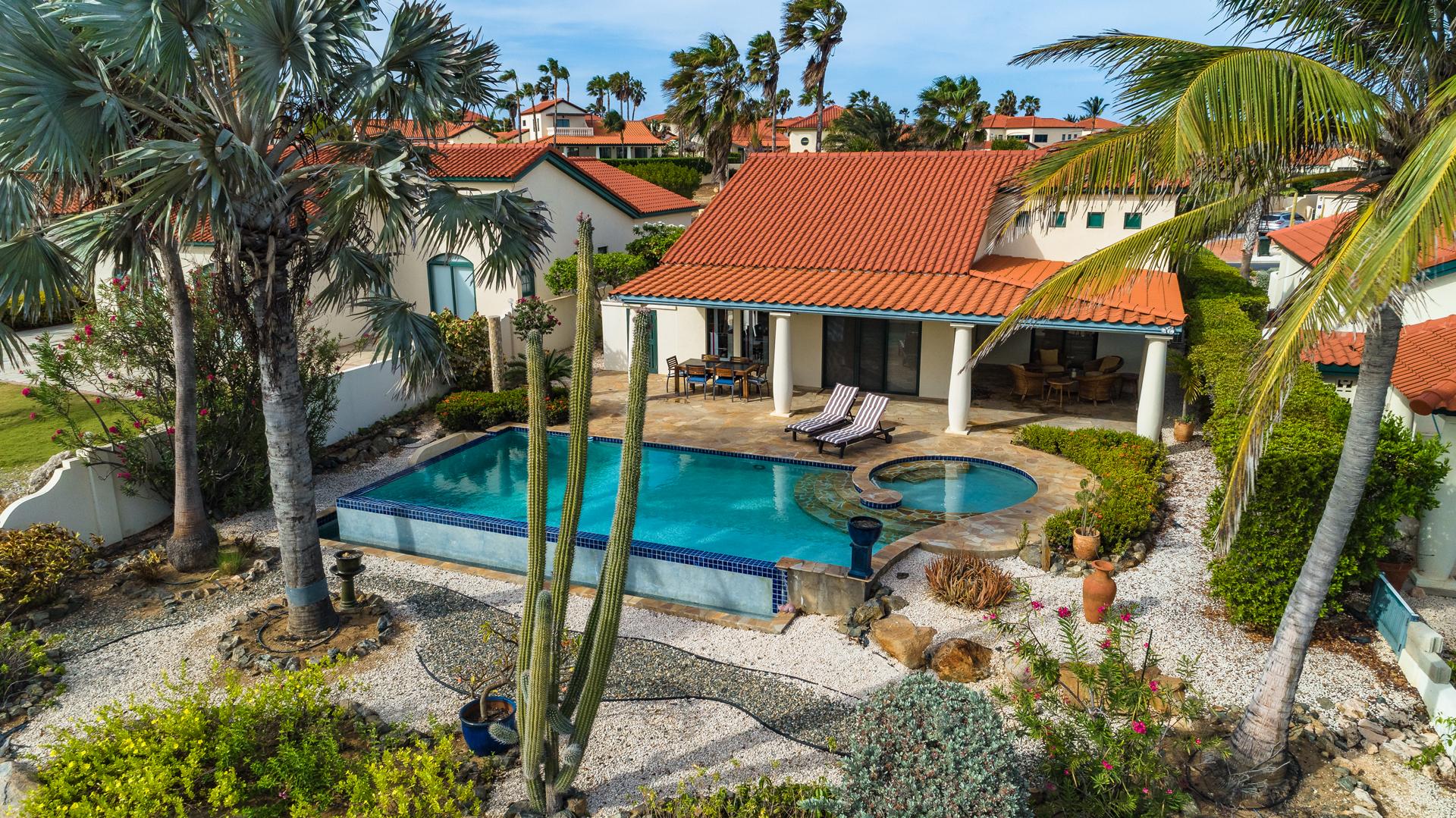 Aerial view of an Aruban villa with pool and cactus garden