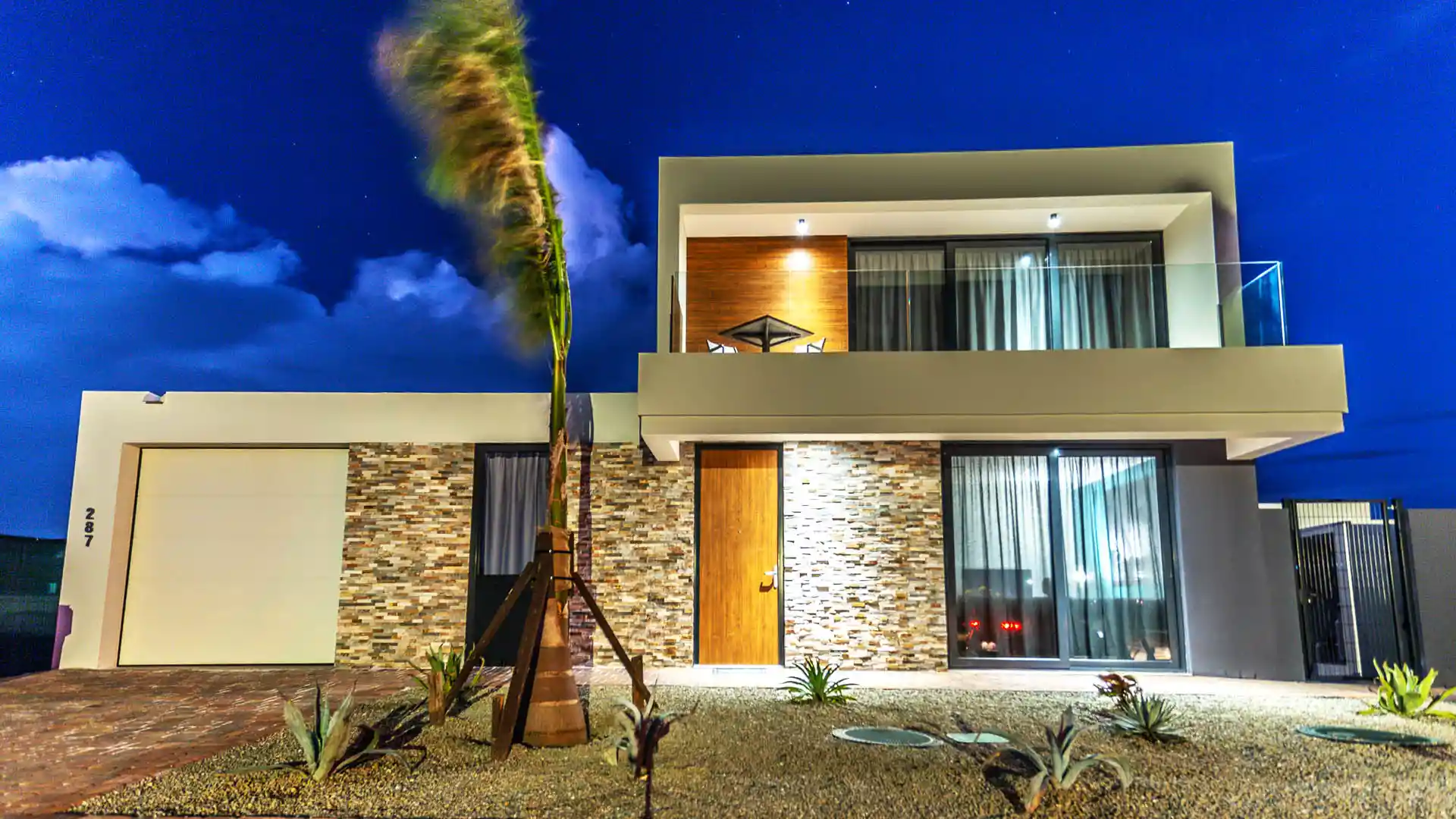 Contemporary villa lit up at dusk