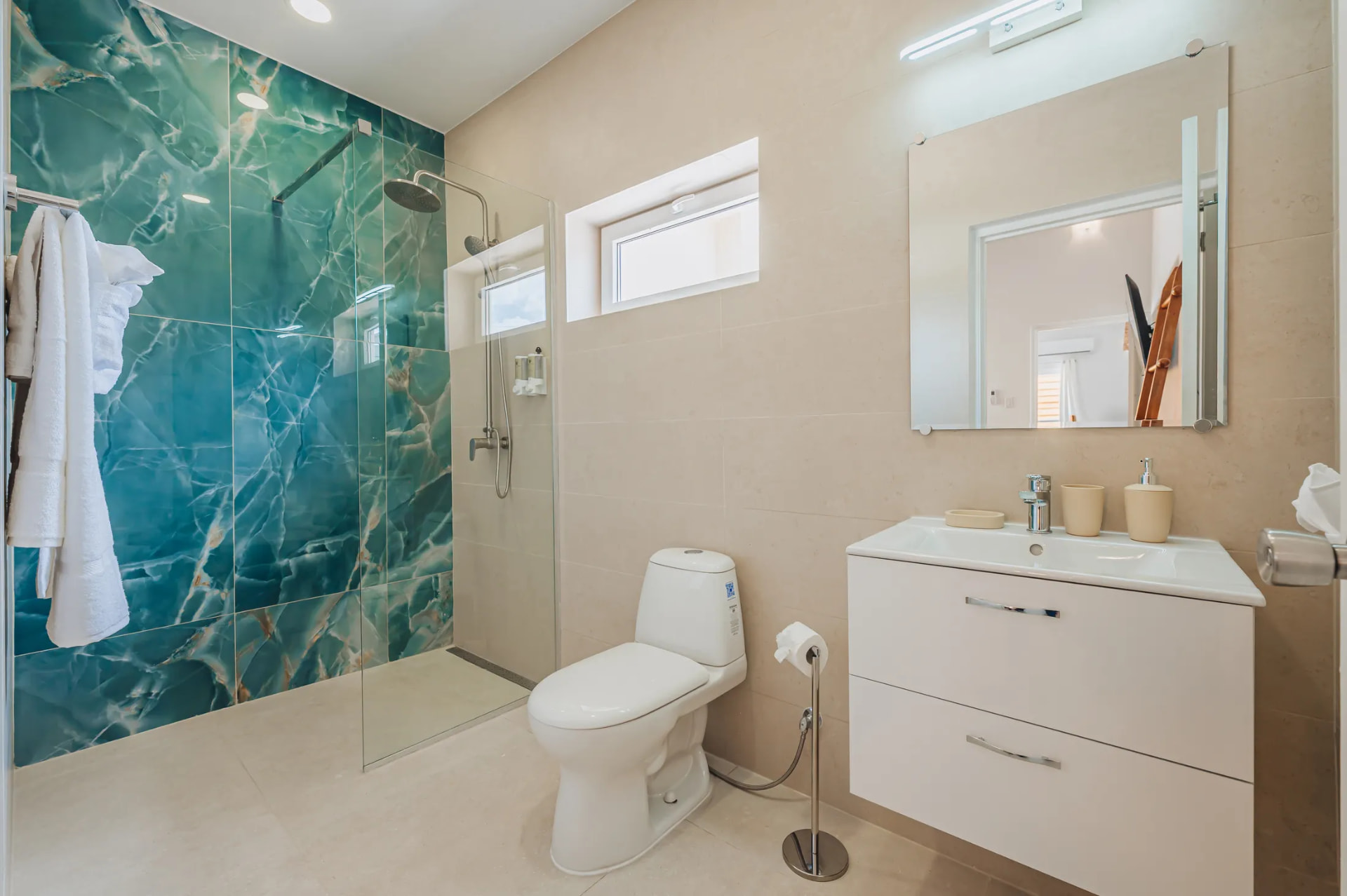 Modern villa bathroom with green marble walk-in shower