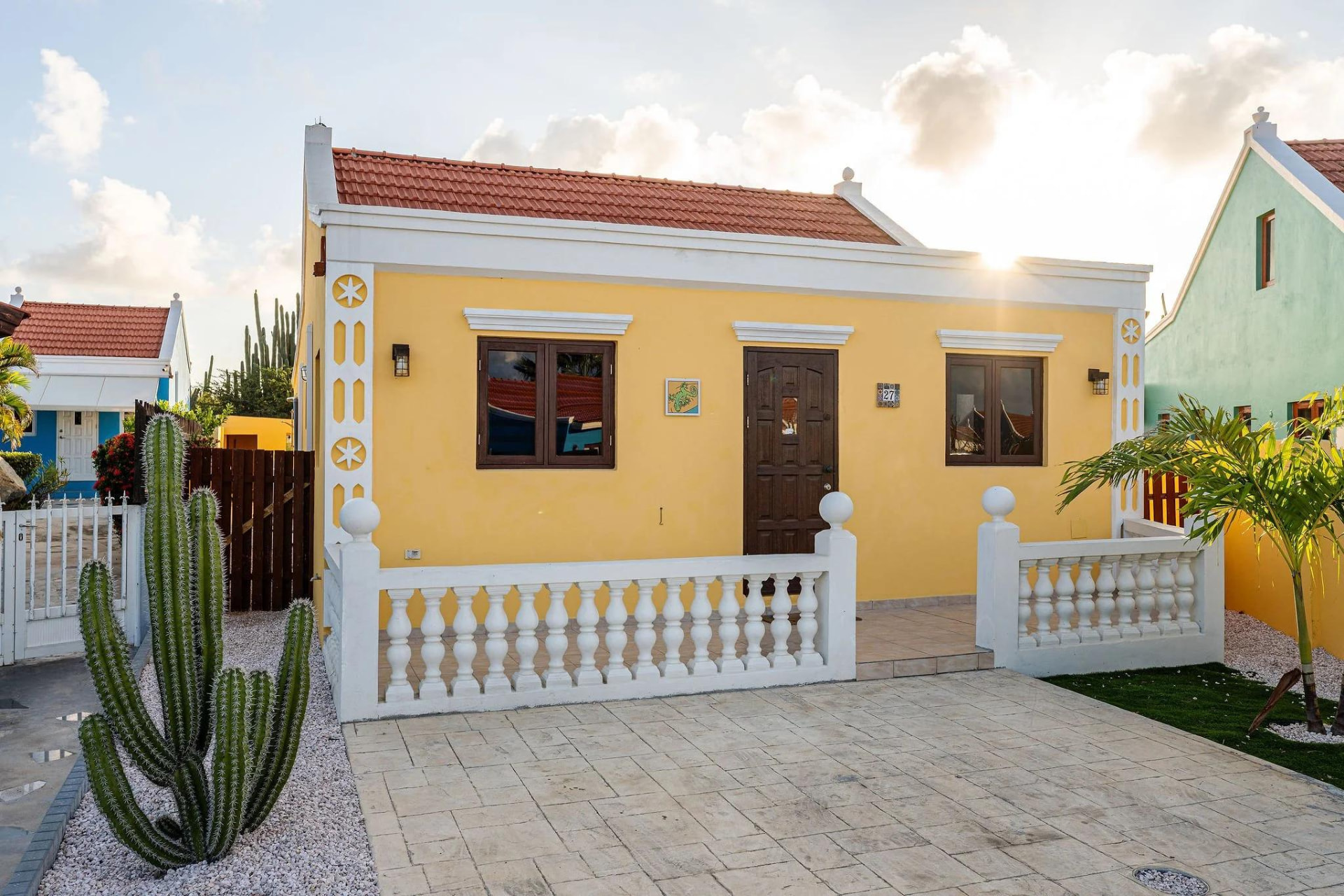 Restored yellow Aruban cunucu house with cactus garden